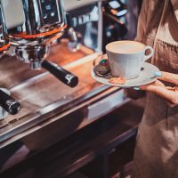 Process of coffee making using brand new coffee machine at cafe by expirienced barista.